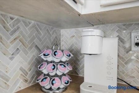 Stylish coffee station with pod brewer and elegant tile backsplash at Blue Breezes, Jamaica Beach TX
