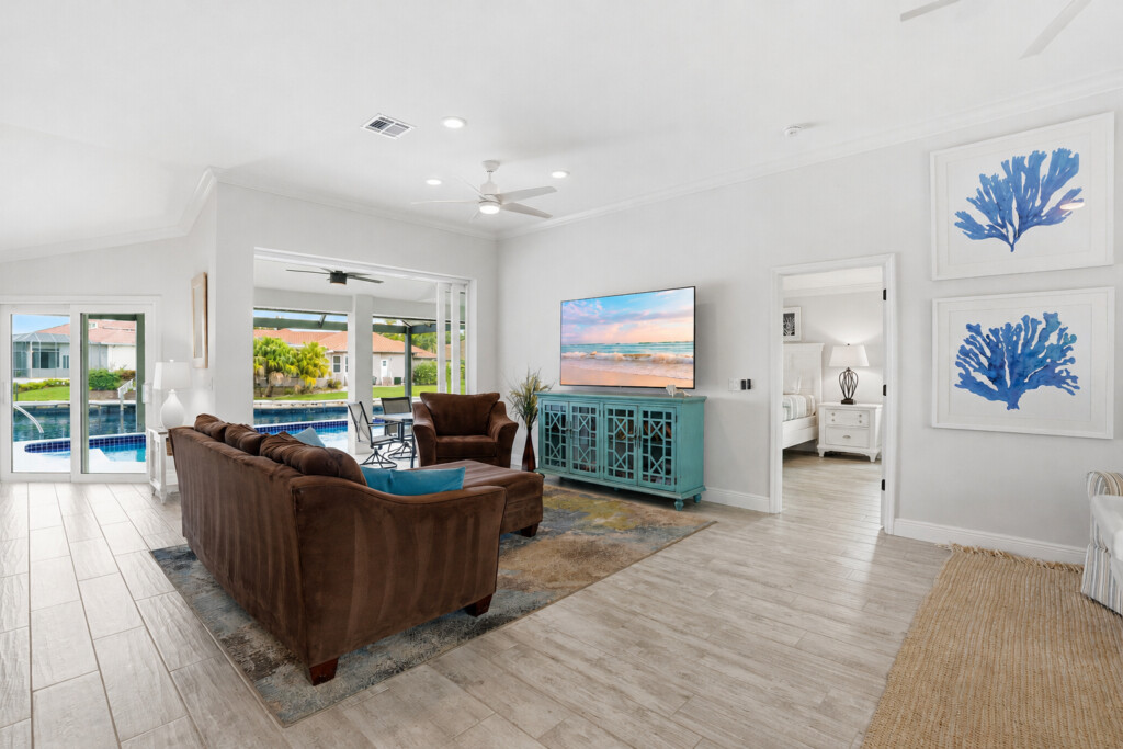 Bright coastal living room with pool views and easy indoor-outdoor flow at Tigertail Beach Villa, Marco Island FL