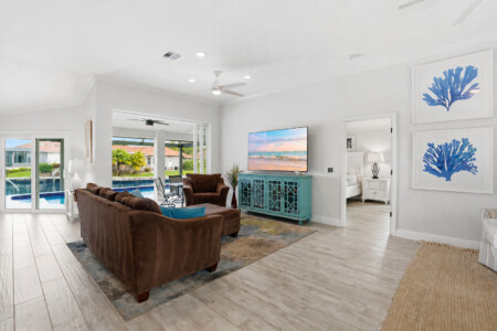 Bright coastal living room with pool views and easy indoor-outdoor flow at Tigertail Beach Villa, Marco Island FL