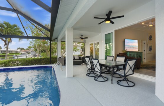 Screened private pool with covered lanai dining and relaxing canal views at Tigertail Beach Villa, Marco Island FL