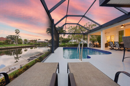 Screened waterfront pool oasis with sunset views and relaxing lounge space at Tigertail Beach Villa, Marco Island FL