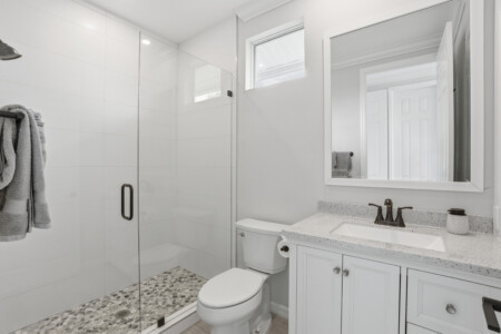 Bright modern bathroom with glass walk-in shower and spa-like finishes at Tigertail Beach Villa, Marco Island FL