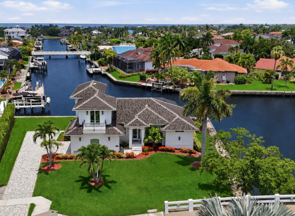 Tropical waterfront retreat with canal views, dock access, and lush lawn at Tigertail Beach Villa, Marco Island FL