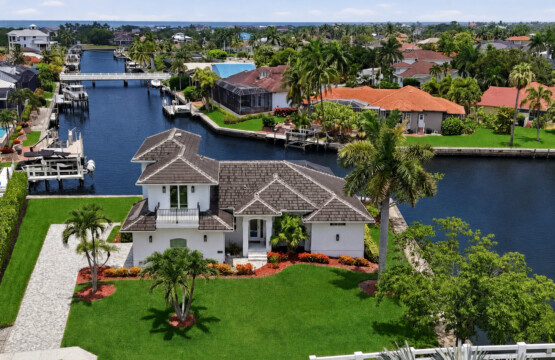 Tropical waterfront retreat with canal views, dock access, and lush lawn at Tigertail Beach Villa, Marco Island FL