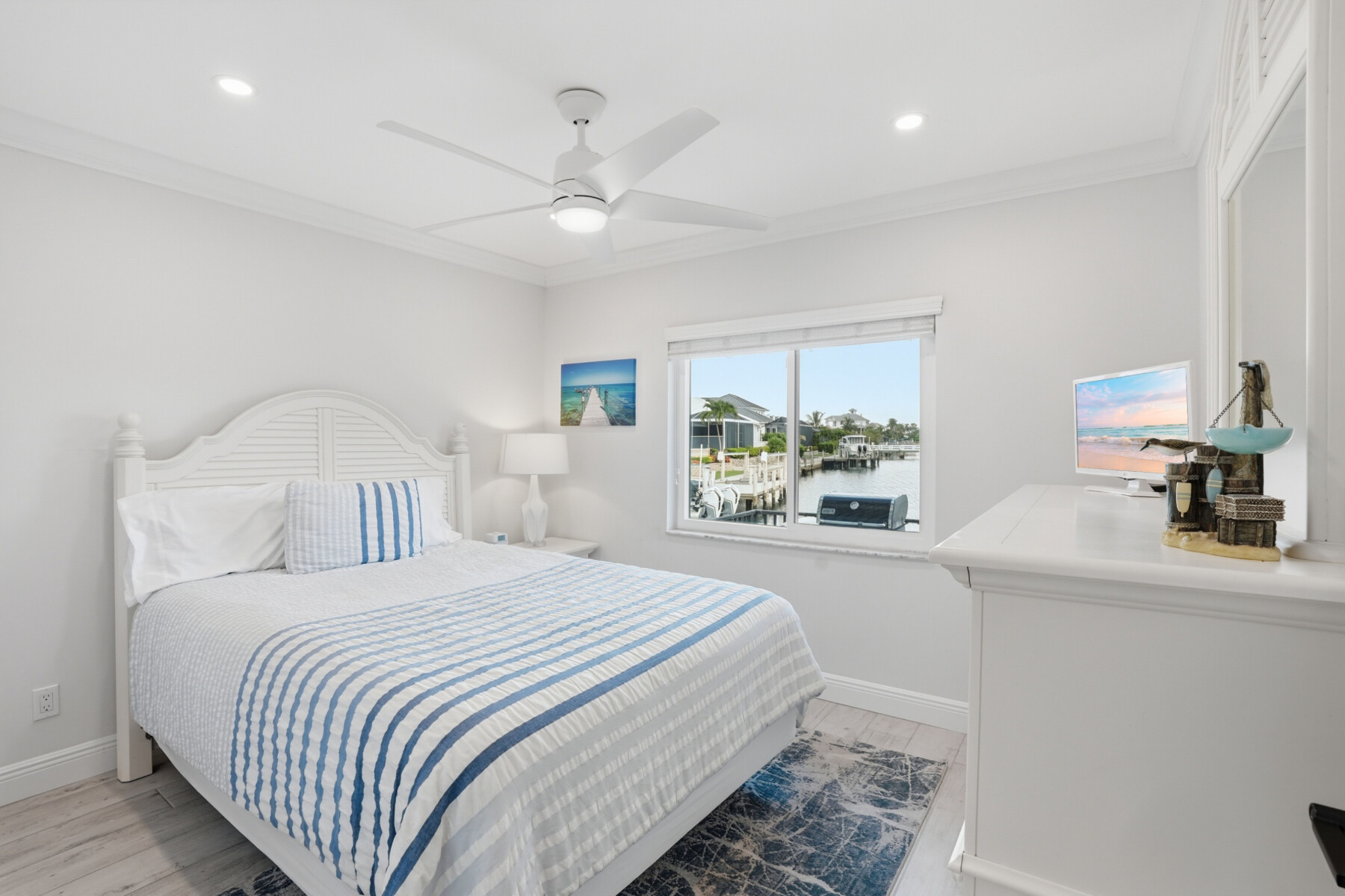 Bright coastal bedroom with waterfront views and crisp, relaxing decor at Tigertail Beach Villa, Marco Island FL