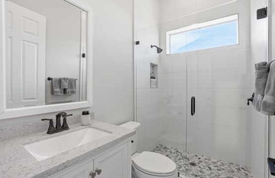 Bright modern bathroom with walk-in glass shower and stylish finishes at Tigertail Beach Villa, Marco Island FL