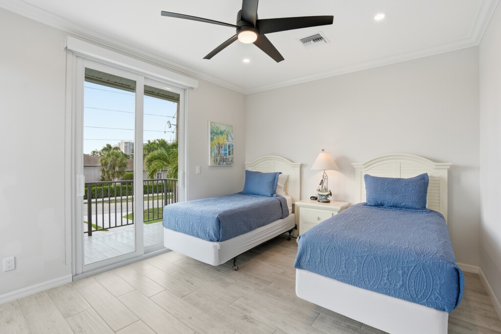 Bright twin bedroom with balcony access and airy coastal style at Tigertail Beach Villa, Marco Island FL