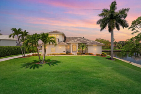 Tropical waterfront home with lush lawn and stunning sunset views at Tigertail Beach Villa, Marco Island FL