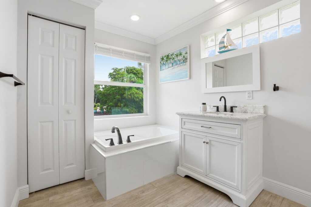 Bright spa-like bathroom with soaking tub and stylish modern vanity at Tigertail Beach Villa, Marco Island FL