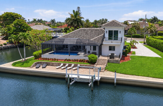 Waterfront retreat with private dock, screened pool, and lush outdoor space at Tigertail Beach Villa, Marco Island FL