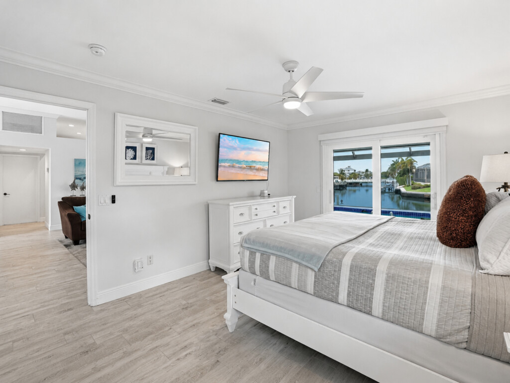 Bright waterfront bedroom with serene views and airy coastal style at Tigertail Beach Villa, Marco Island FL