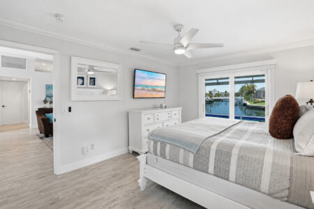 Bright waterfront bedroom with serene views and airy coastal style at Tigertail Beach Villa, Marco Island FL