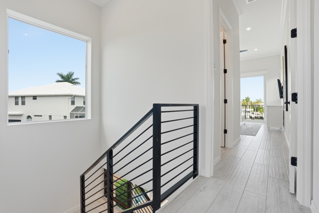 Bright modern upstairs hallway with natural light and tropical views at Tigertail Beach Villa, Marco Island FL