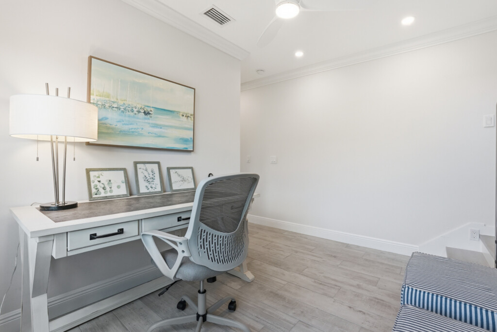 Bright coastal-inspired workspace with desk and ergonomic chair at Tigertail Beach Villa, Marco Island FL