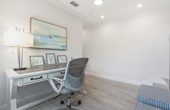Bright coastal-inspired workspace with desk and ergonomic chair at Tigertail Beach Villa, Marco Island FL