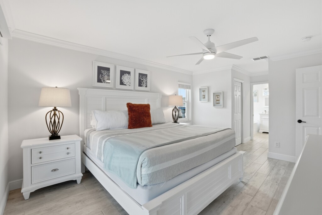 Bright coastal-style king bedroom with elegant furnishings and airy feel at Tigertail Beach Villa, Marco Island FL