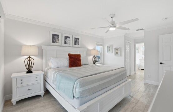 Bright coastal-style king bedroom with elegant furnishings and airy feel at Tigertail Beach Villa, Marco Island FL
