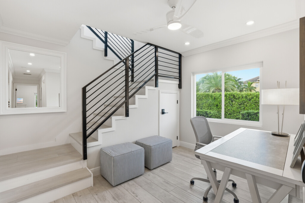 Bright modern workspace with natural light and sleek staircase design at Tigertail Beach Villa, Marco Island FL