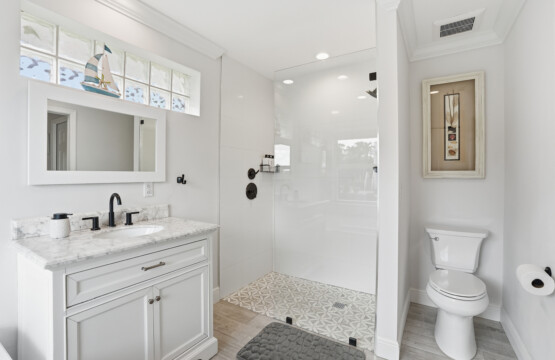 Bright spa-style bathroom with walk-in glass shower and elegant finishes at Tigertail Beach Villa, Marco Island FL
