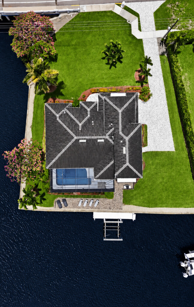 Waterfront retreat with private dock, pool, and lush tropical grounds at Tigertail Beach Villa, Marco Island FL