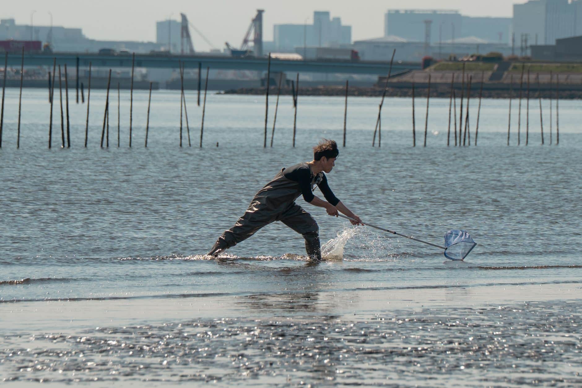 Fisherman holding large redfish on Galveston Bay during fall fishing season